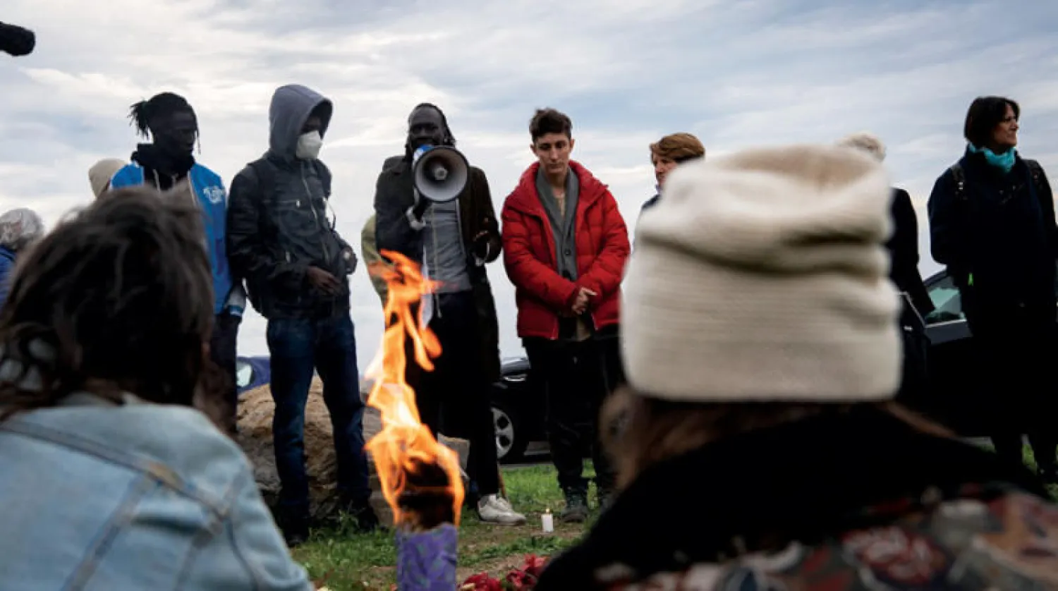 مهاجرون تجمعوا لوداع زميل لهم قضى بعد أن دهسته سيارة في مدينة فينتيميليا الإيطالية قرب الحدود الفرنسية (أ.ب)