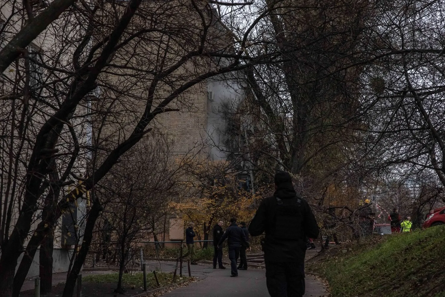 Members of the police stand guard next to a residential building that was hit during a Russian attack, in Kyiv, Ukraine, 15 November 2022. (EPA)