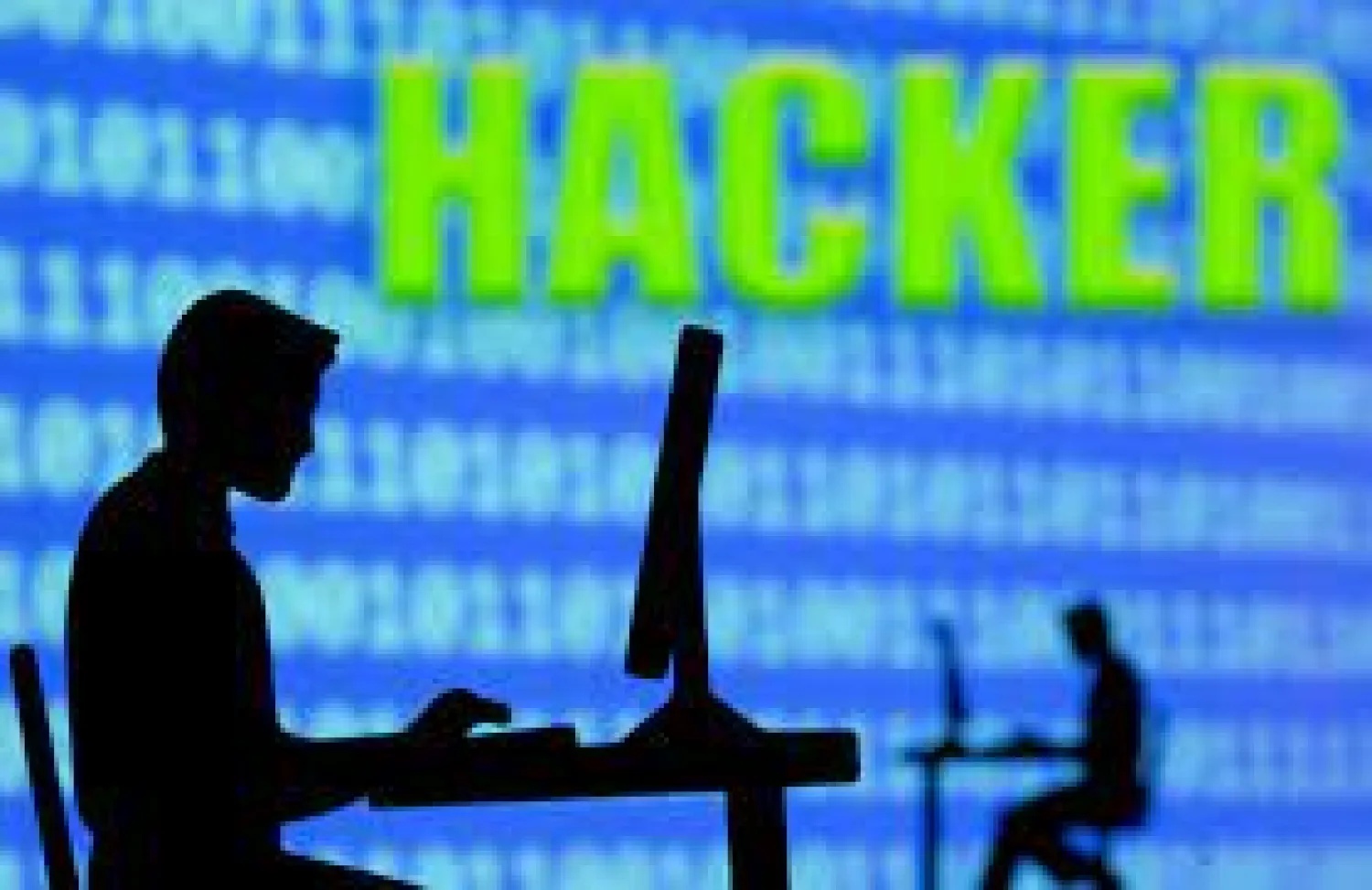  A 3D printed model of men working on computers are seen in front of displayed binary code and words "Hacker" in this illustration taken, July 5, 2021. REUTERS/Dado Ruvic/Illustration
