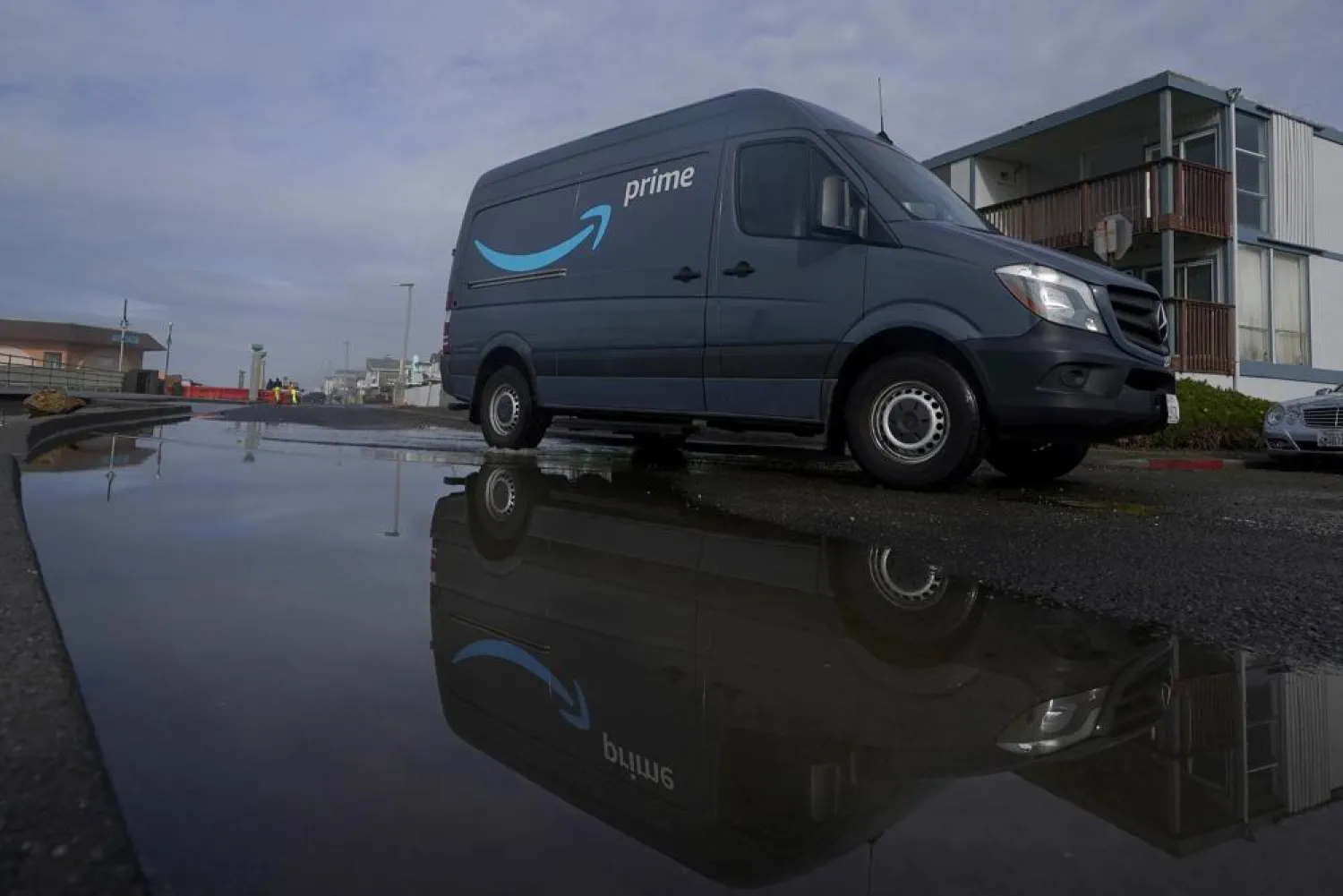 File Photo- An Amazon Prime truck drives in Pacifica, Calif., on Dec. 15, 2020. Amazon has begun mass layoffs in its corporate ranks, becoming the latest tech company to trim its workforce amid rising fears about the wider economic environment. (AP Photo/Jeff Chiu, File)
