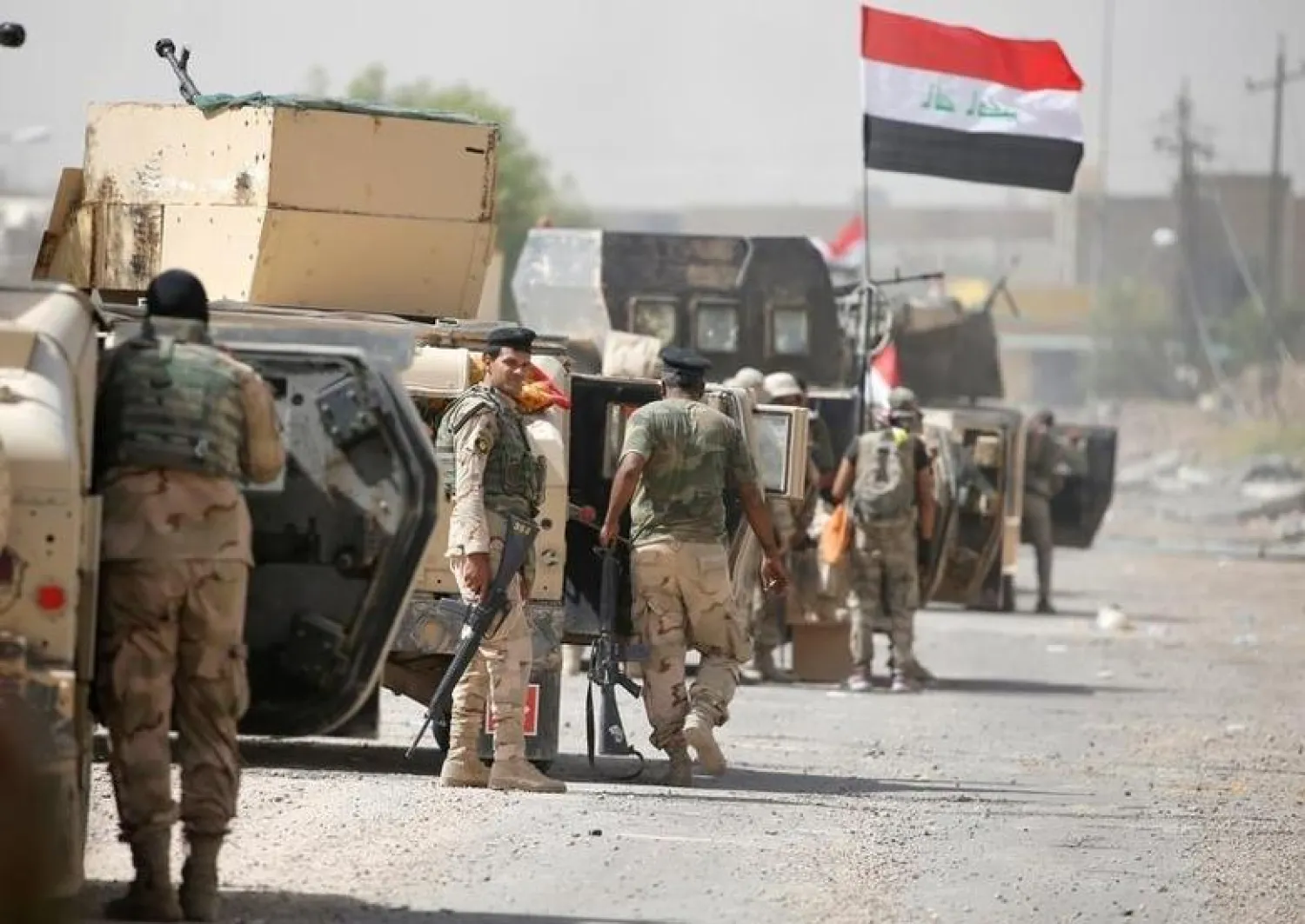 Iraqi army soldiers carry their weapons as they gather in the center of Fallujah, Iraq, June 17, 2016. REUTERS/Thaier Al-Sudani