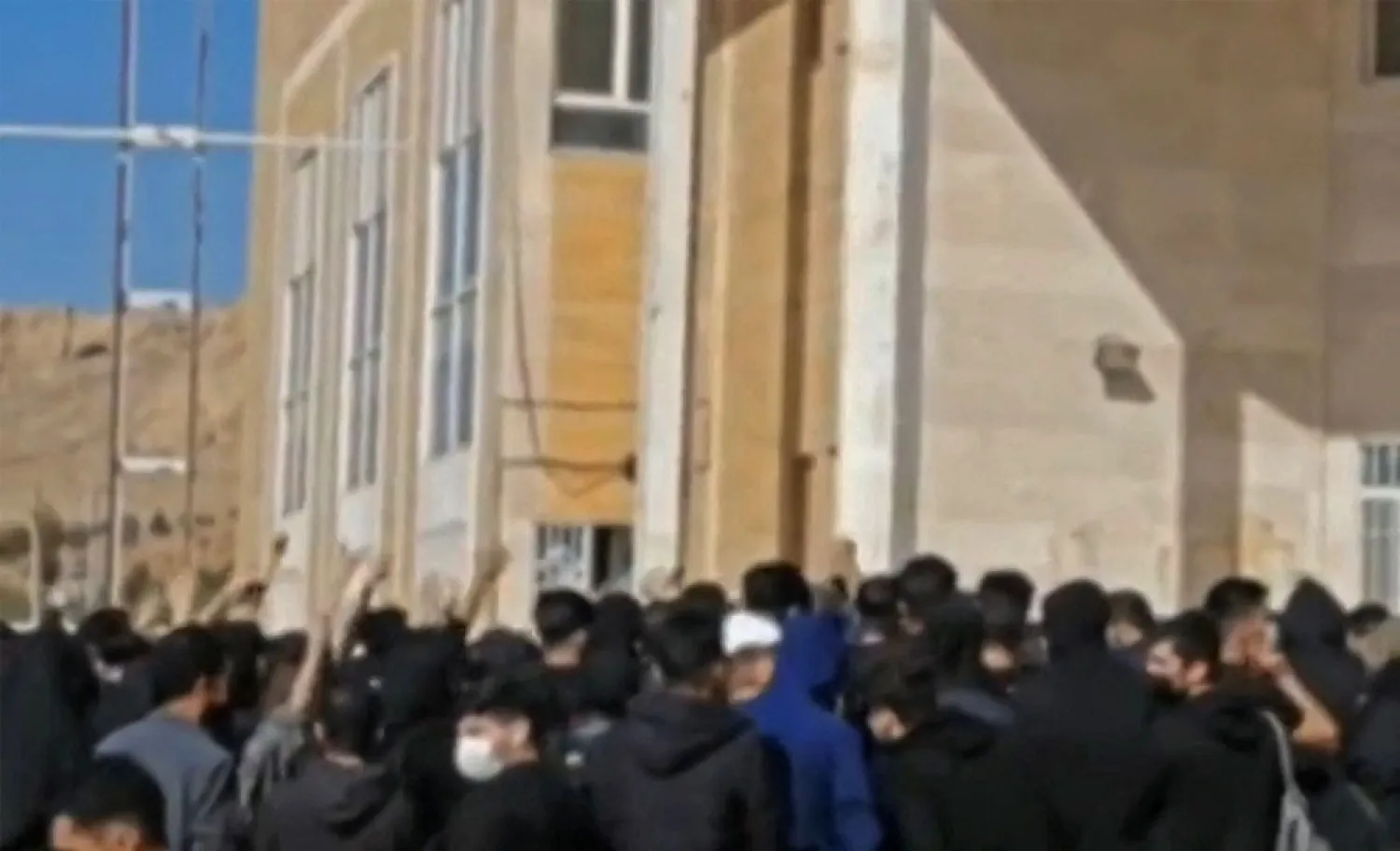 This grab taken from a UGC video made available on the ESN platform on November 15, 2022, reportedly shows Iranian Students chanting slogans at the Kermanshah university in support of the protest movement in western Iran's city of Kermanshah. 
(Photo by Anonymous/AFP)