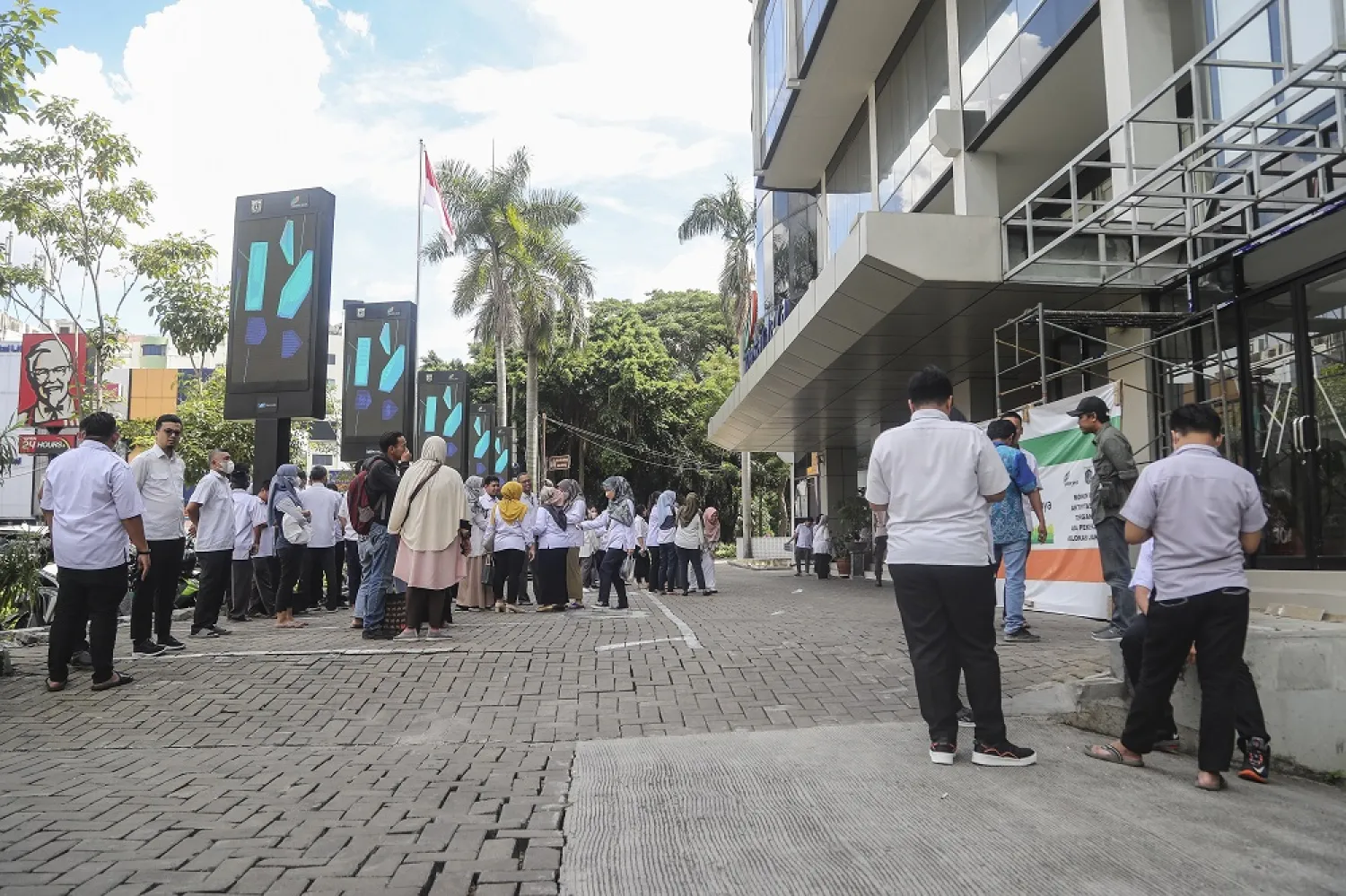 People stay outside amid fears of aftershocks following an earthquake at a business area in Jakarta, Indonesia, 21 November 2022. (EPA)