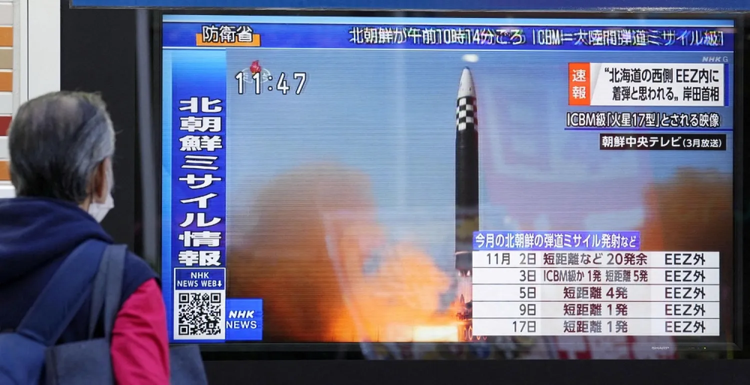 A passerby looks at a television screen showing a news report about North Korea firing a ballistic missile in Tokyo, Japan November 18, 2022. (Kyodo via Reuters)