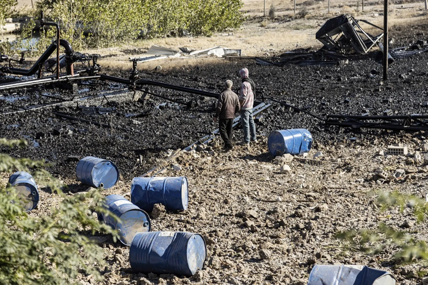 People inspect a site damaged by Turkish airstrikes that hit an electricity station in the village of Taql Baql, in Hasakeh province, Syria, Sunday, Nov. 20, 2022. (AP)