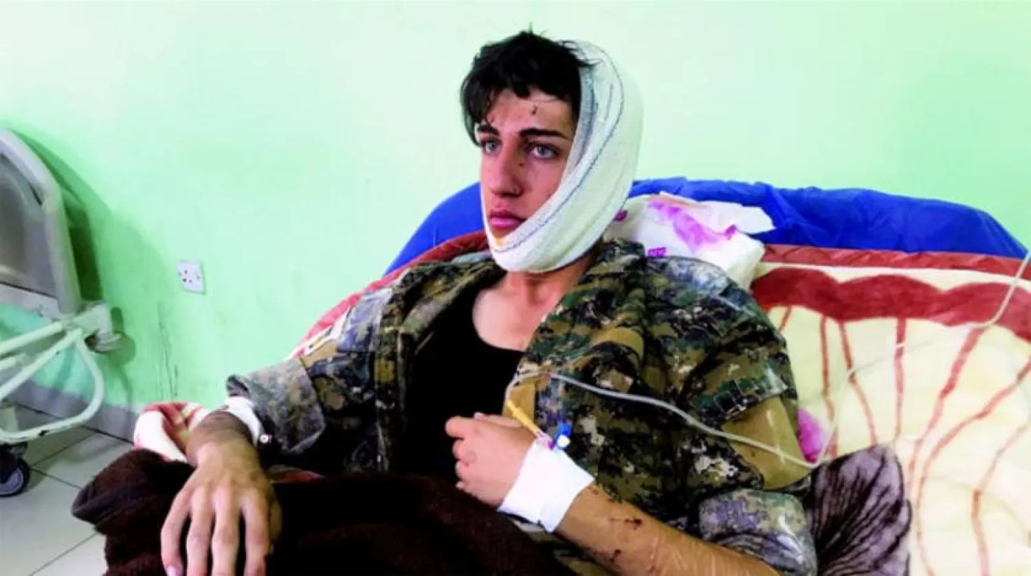 A young man is treated in hospital after he was injured in an Iranian strike on Koya, near Erbil recently (Reuters)