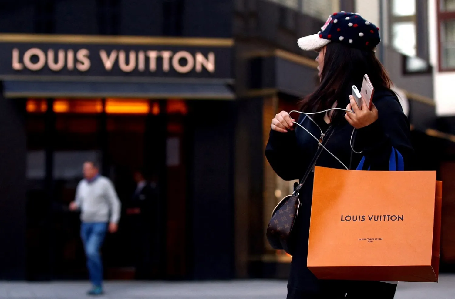 A woman with a Louis Vuitton-branded shopping bag in Vienna, Austria October 4, 2018. (Reuters)