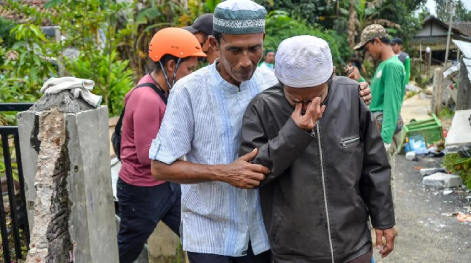 A man cries before the funeral of his child who was found dead after Monday's earthquake in Cianjur, West Java province, Indonesia, November 25, 2022, in this photo taken by Antara Foto. Antara Foto/Raisan Al Farisi/ via REUTERS 