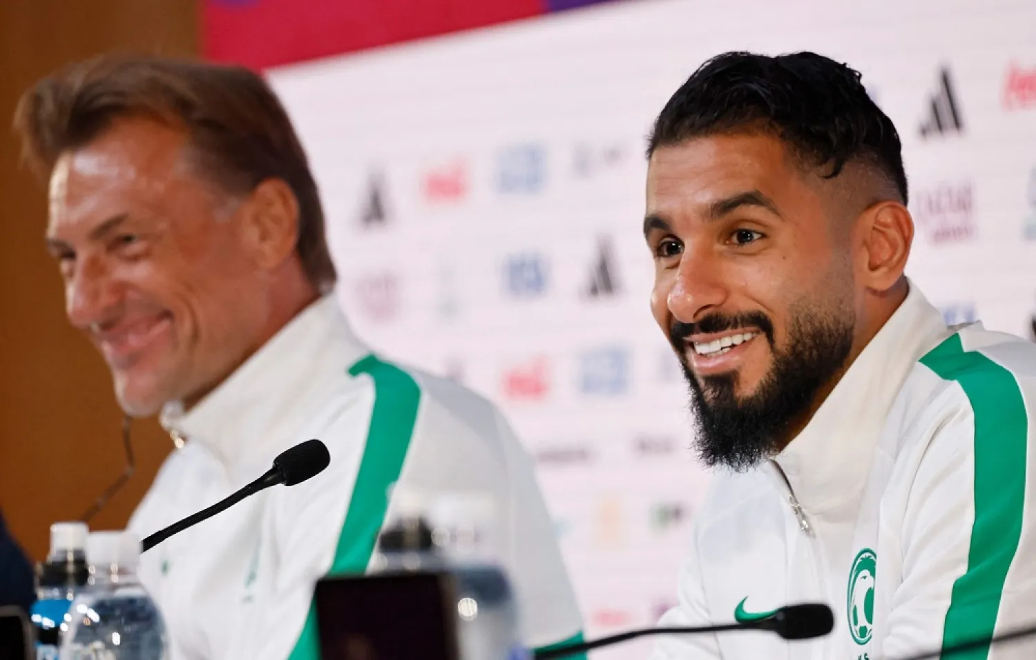 Saudi Arabia's French coach Herve Renard and Saleh Saudi Arabia's forward Saleh Al-Shehri (R) give a press conference at the Qatar National Convention Center (QNCC) in Doha on November 25, 2022, on the eve of the Qatar 2022 World Cup football match between Poland and Saudi Arabia. (AFP)