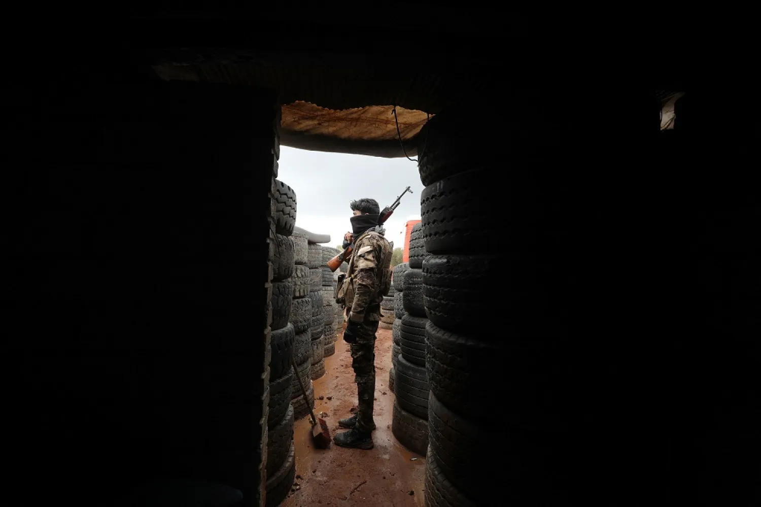 Türkiye-backed Syrian fighters man positions on the outskirts of the town of Kuljibrin, in the country's northern Aleppo governorate, facing positions of the Kurdish-controlled area of Tal Rifaat, on November 25, 2022.(AFP)