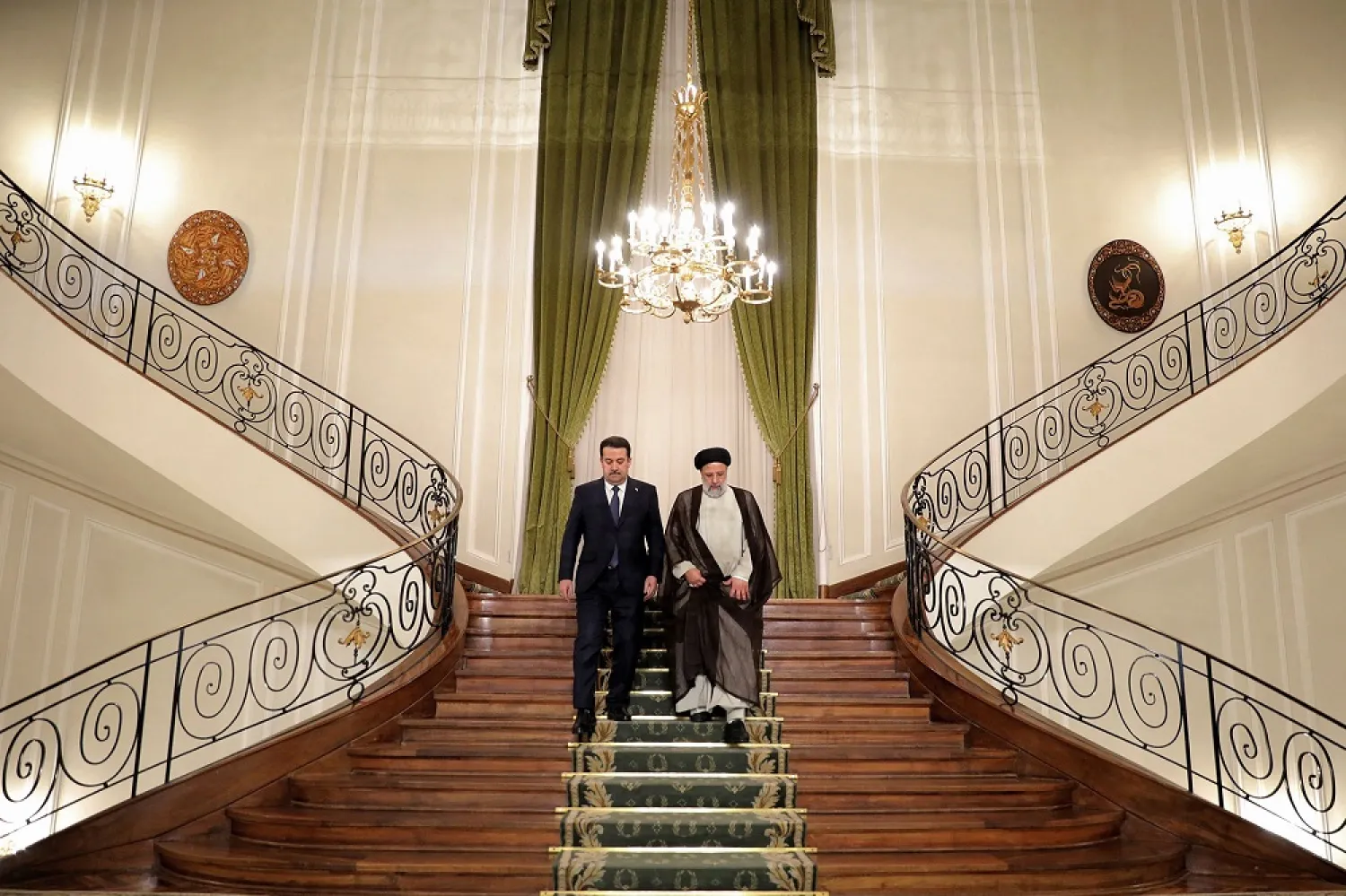This handout picture provided by the Iranian presidency shows Iran's President Ebrahim Raisi (R) and Iraq's Prime Minister Mohammed Shia al-Sudani (L) arriving for a joint press conference in the capital Tehran on November 29, 2022. (Photo by Iranian Presidency / AFP)
