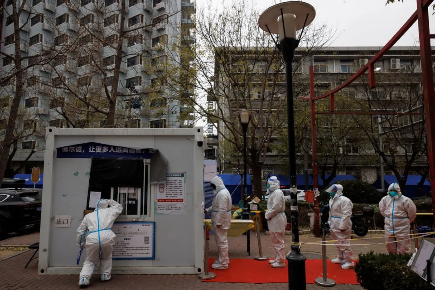 Epidemic-prevention workers in protective suits line up to get swab tested as outbreaks of coronavirus disease (COVID-19) continue in Beijing, China November 28, 2022. REUTERS/Thomas Peter