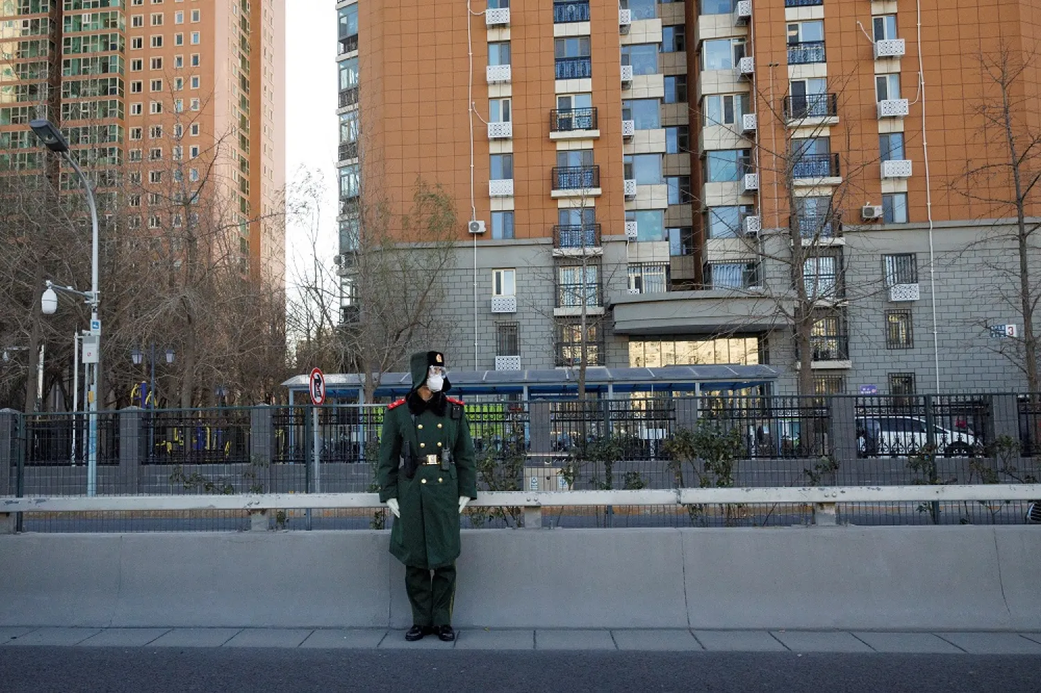 A member of the Chinese People's Armed Police Force wears a face mask as he keeps watch on a street amid coronavirus disease (COVID-19) outbreaks in Beijing, December 1, 2022. (Reuters)