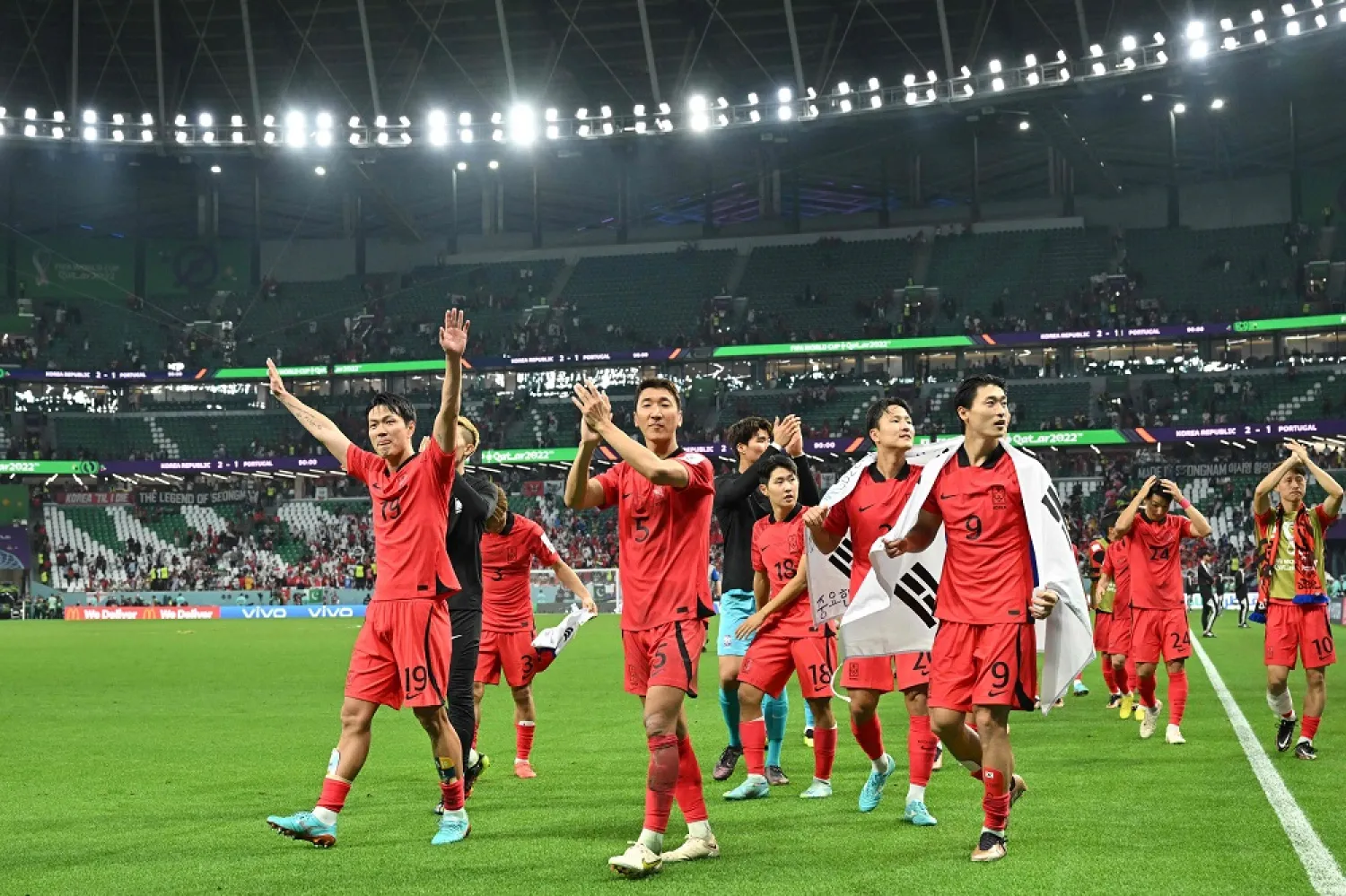 South Korea's players celebrate qualifying for the World Cup last 16 at the end of the Qatar 2022 World Cup Group H football match between South Korea and Portugal at the Education City Stadium in Al-Rayyan, west of Doha on December 2, 2022. (AFP)