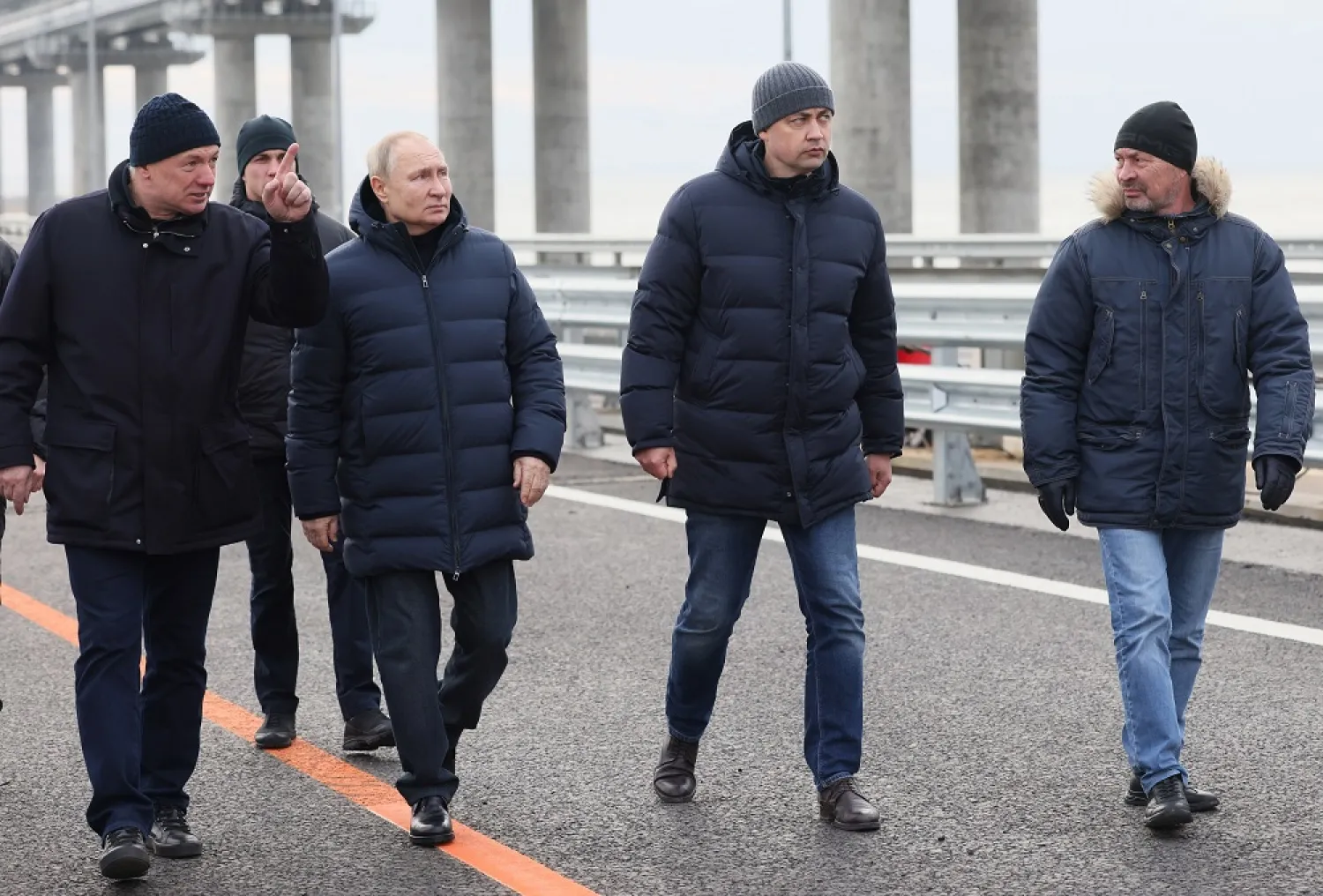 Russian President Vladimir Putin, third right, listens to Deputy Prime Minister Marat Khusnullin, left, as he visits the Crimean Bridge connecting Russian mainland and Crimean peninsula over the Kerch Strait, which was damaged by a truck bomb attack in October, after restoration works, not far from Kerch, Crimea, Monday, Dec. 5, 2022. (Sputnik, Kremlin Pool Photo via AP)