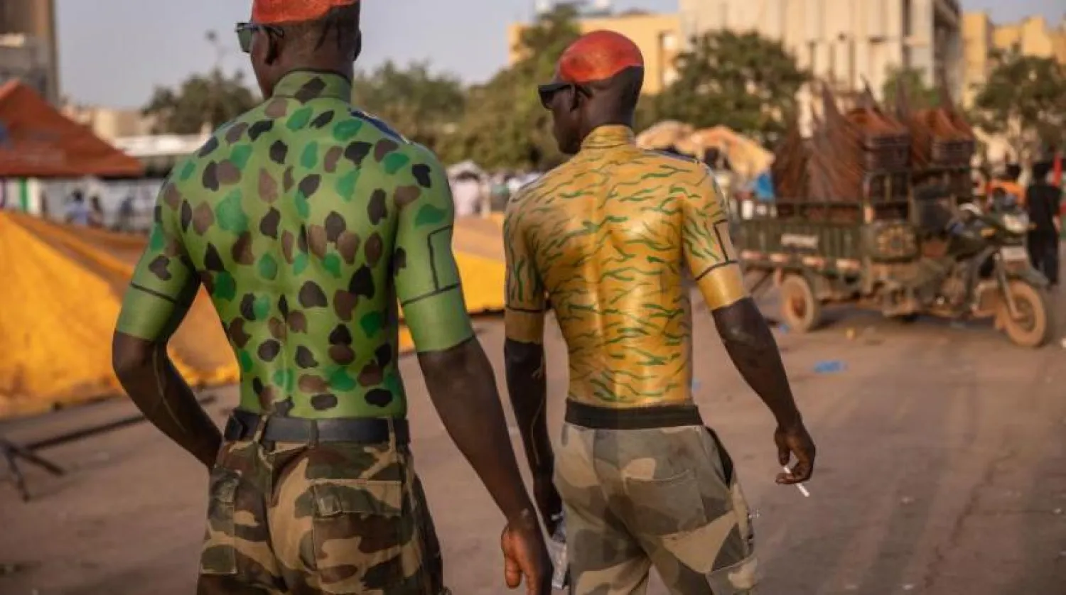 Vagadugu'da erkekler orduyu desteklemek için vücutlarını askeri üniformaların renklerine boyadı (AFP)