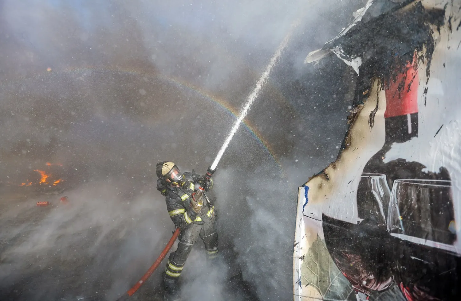 A firefighter works to extinguish fire at market stalls hit by shelling in the course of Russia-Ukraine conflict in Donetsk, Russian-controlled Ukraine, December 6, 2022. (Reuters)