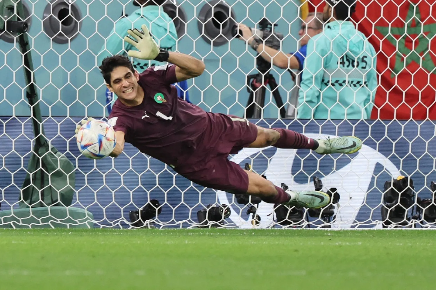 Morocco's goalkeeper #01 Yassine Bounou deflects a penalty kick from Spain's midfielder #05 Sergio Busquets during the Qatar 2022 World Cup round of 16 football match between Morocco and Spain at the Education City Stadium in Al-Rayyan, west of Doha on December 6, 2022. (AFP)