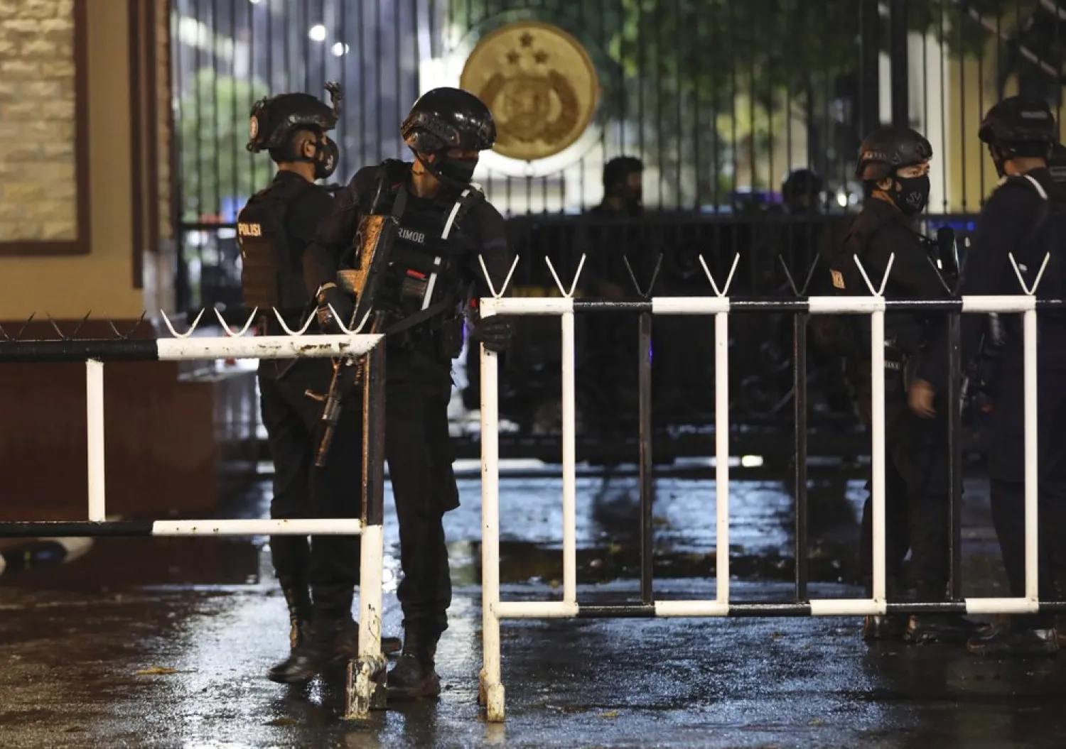 Officers set up a barricade at the gate of the National Police Headquarters following a suspected militant attack in Jakarta, Indonesia, Wednesday, March 31, 2021. (AP Photo/Dita Alangkara)

