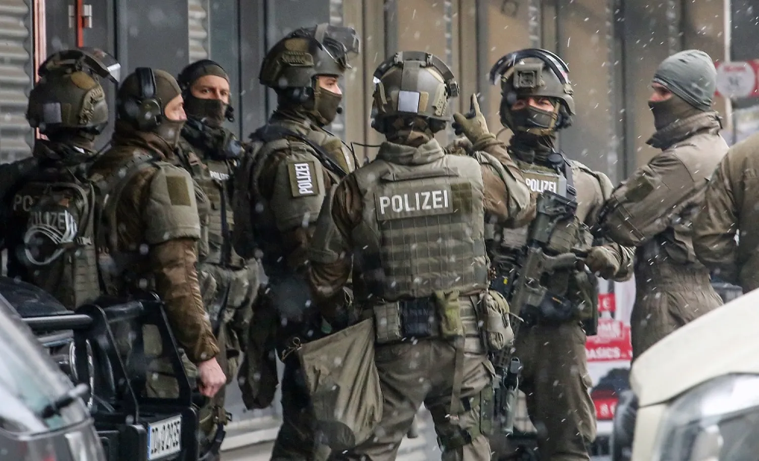 Members of a special police task force unit secure the area near a shopping center in Dresden, Germany, 10 December 2022. (EPA)