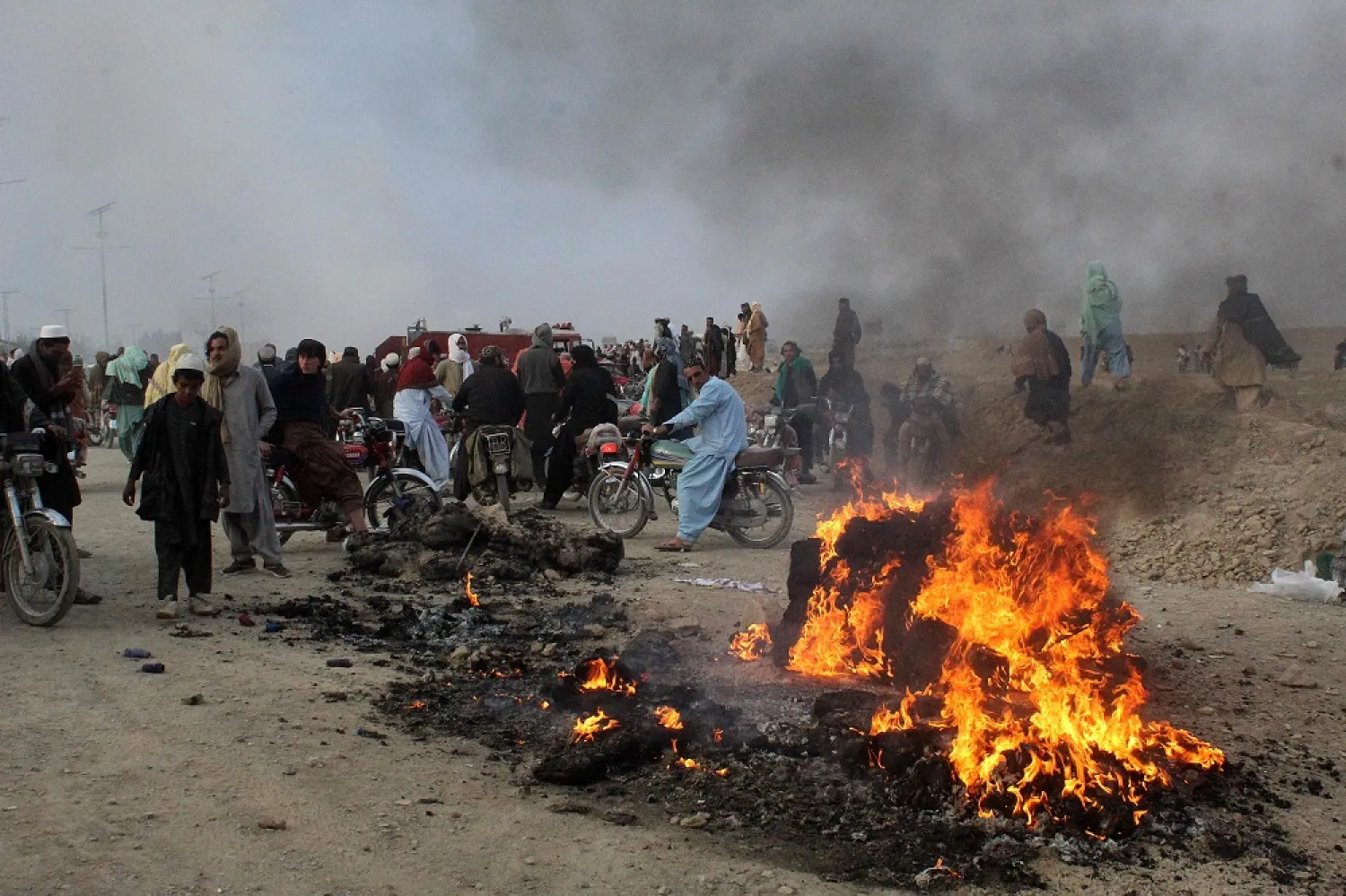 Residents gather after Taliban forces fired mortars at Pakistan's border town of Chaman on December 11, 2022. (AFP)