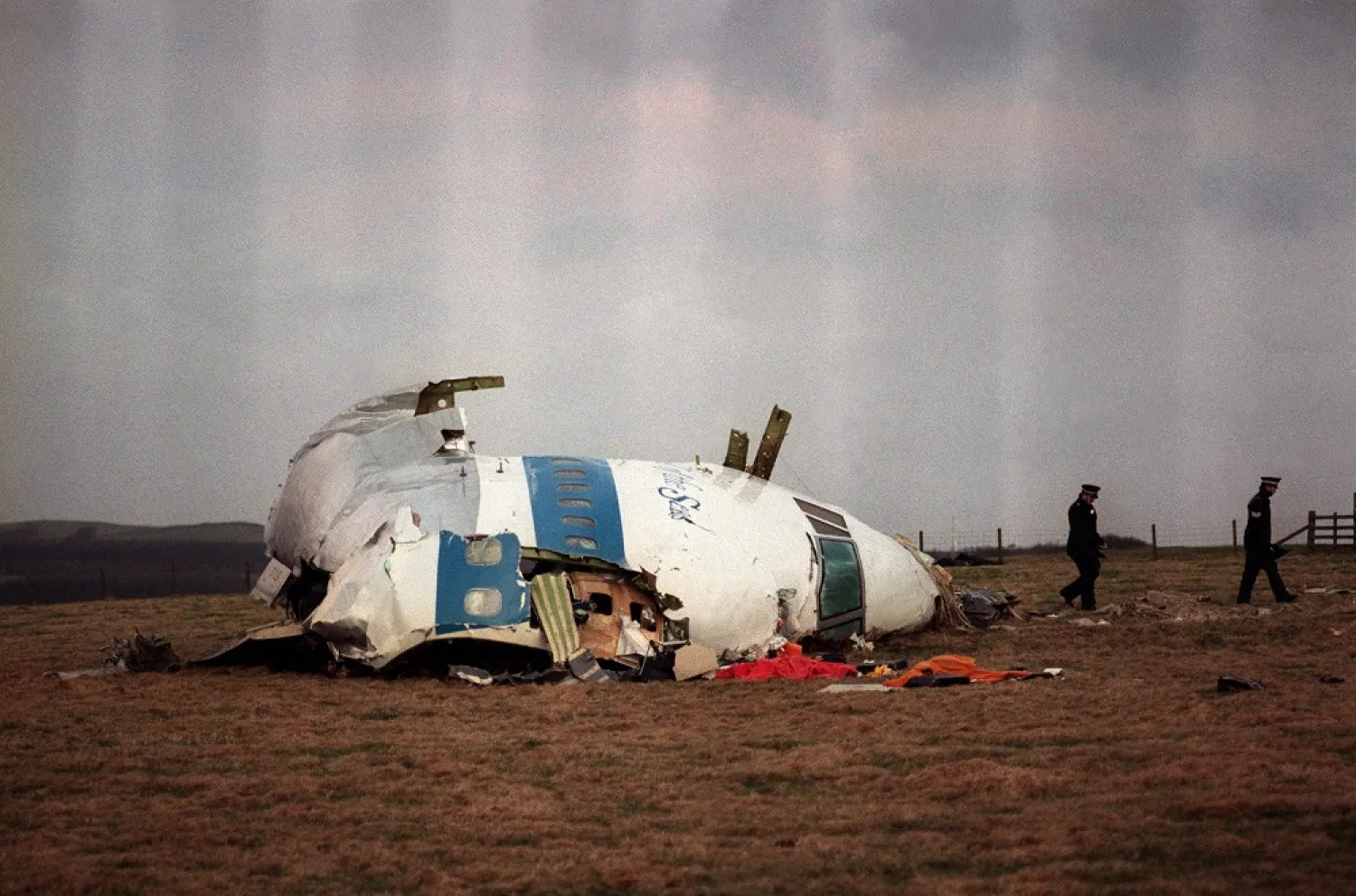 In this file photo taken on December 22, 1988 policemen walk away from the cockpit of the 747 Pan Am airliner that exploded and crashed over Lockerbie, Scotland. (AFP)