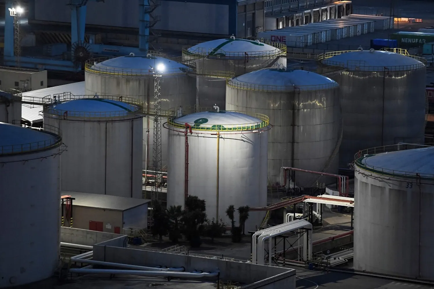 This photograph taken on December 11, 2022 shows storage tanks at the facilities of the oil products company Exolum at the port of Barcelona. (AFP)