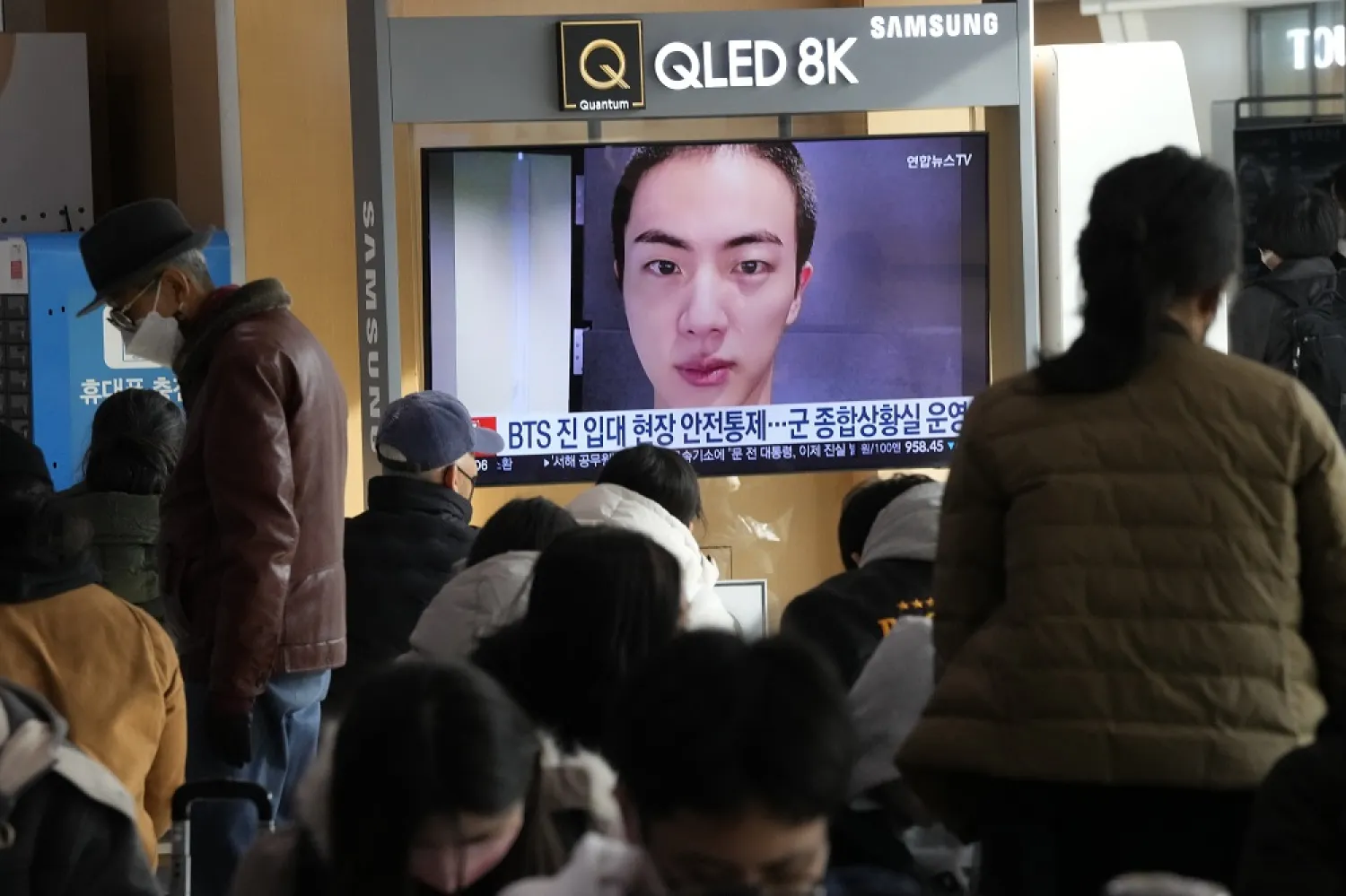 A TV screen shows an image of BTS's member Jin with buzz cut, at the Seoul Railway Station in Seoul, South Korea, Monday, Dec. 12, 2022. (AP)