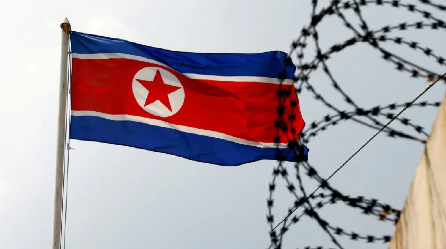 A North Korea flag flutters next to concertina wire at the North Korean embassy in Kuala Lumpur, Malaysia March 9, 2017. REUTERS/Edgar Su
