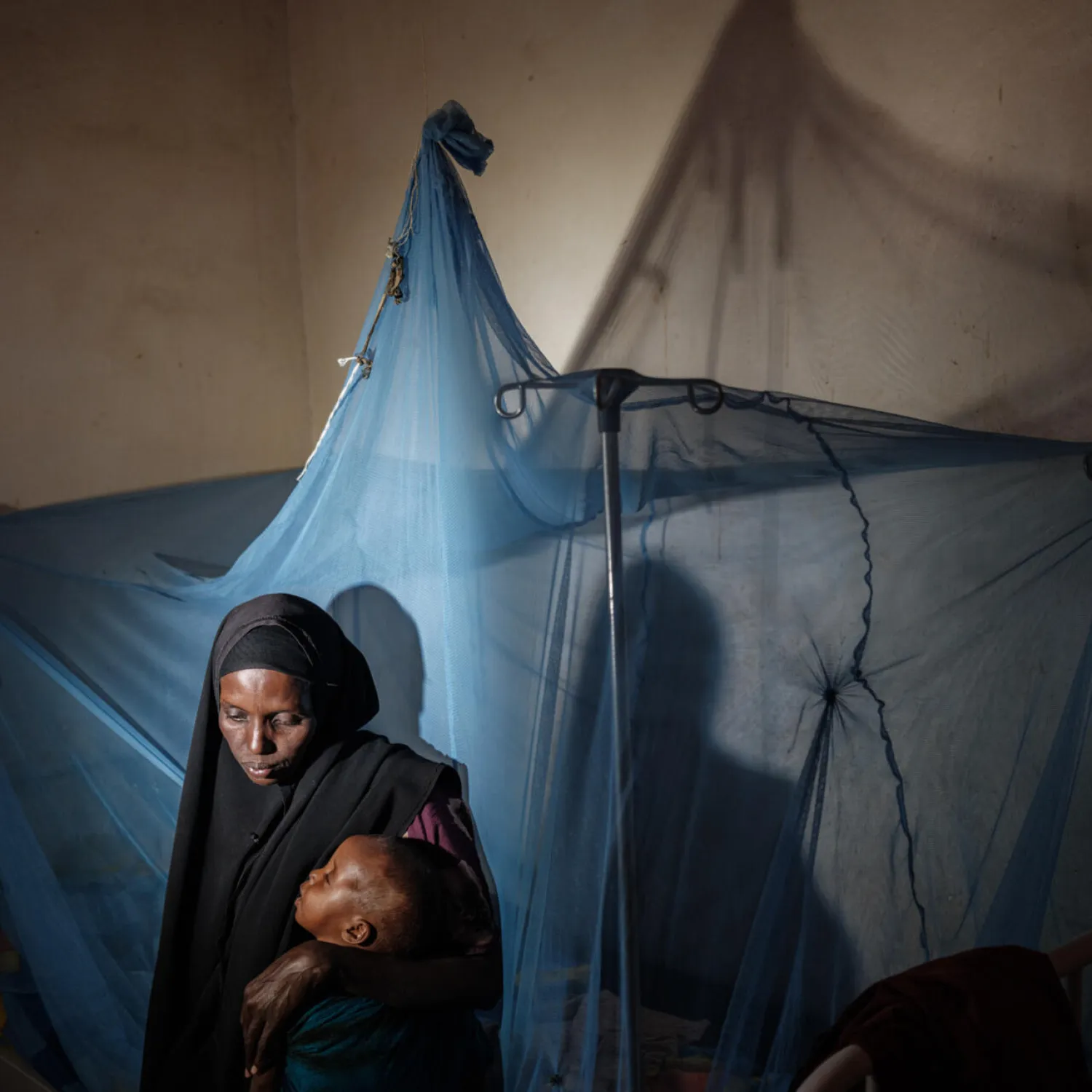 Somalia crisis: Maimun Ali, 31, clutches her two-year-old child at a malnourishment center in Baidoa. YASUYOSHI CHIBA / AFP
