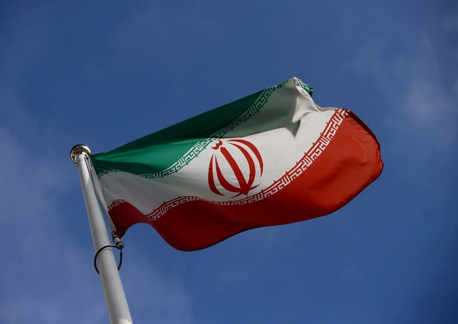 The Iranian flag waves in front of the International Atomic Energy Agency (IAEA) headquarters in Vienna, Austria, March 1, 2021. (Reuters)

