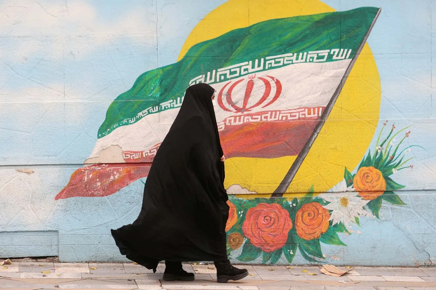 A woman walks down a street in Tehran, Iran December 6, 2022. WANA (West Asia News Agency) via Reuters/File Photo