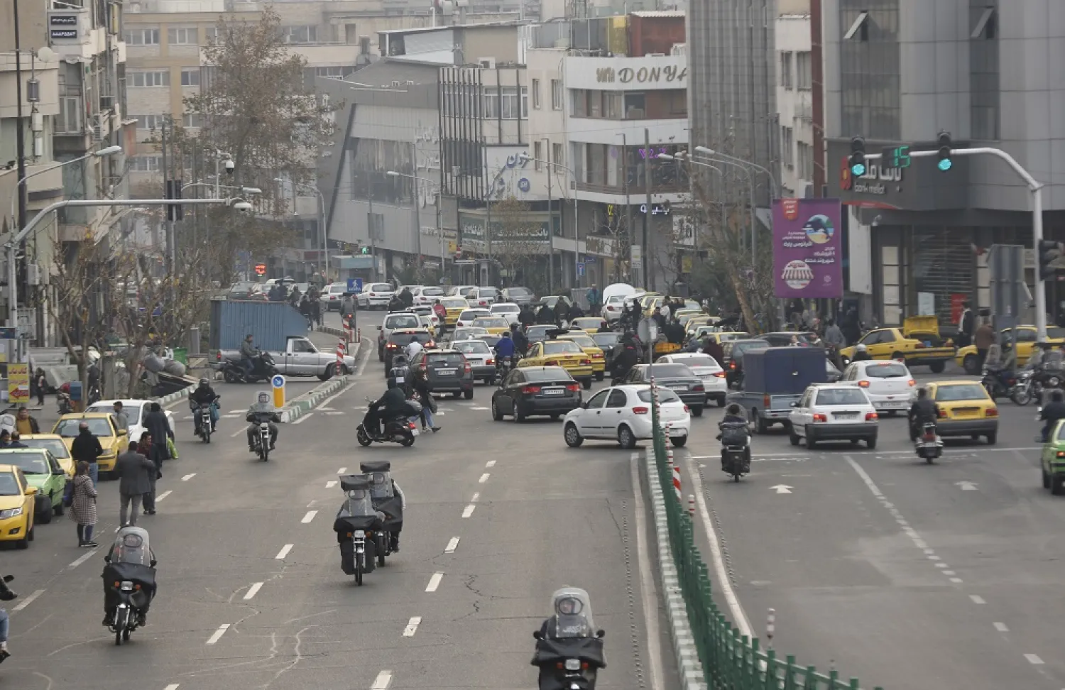 People drive on a street in the capital city of Tehran, Iran, 18 December 2022. (EPA)