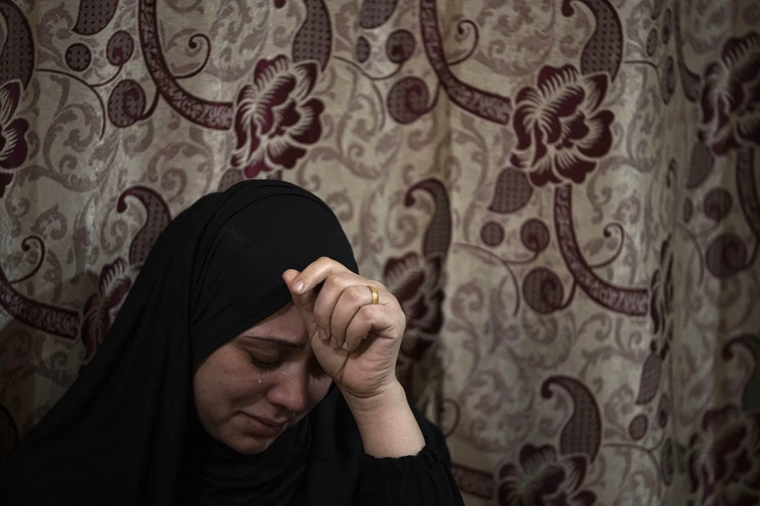A Palestinian woman weeps during the funeral of Mohammed al-Shaer, one of eight young men who drowned off the coast of Tunisia, in Rafah, in the southern Gaza Strip, Sunday, Dec. 18, 2022. (AP)