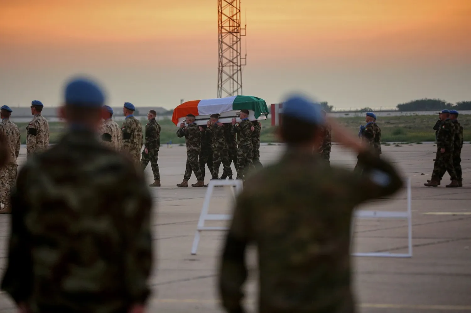 18 December 2022, Lebanon, Beirut: The coffin of Irish peacekeeper serving with the United Nations Interim Force in Lebanon (UNIFIL) Sean Rooney, who was dead earlier this week in South Lebanon, is carried by his colleagues during a repatriation ceremony at Beirut airport before being taken by an Irish military plane back home. (dpa)