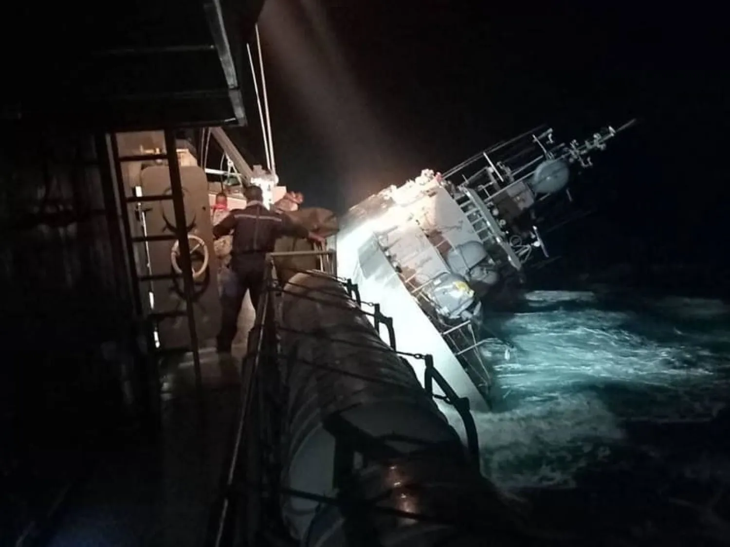 This handout photo taken on December 18, 2022 and released on December 19 by the Royal Thai Navy shows the HTMS Sukhotha warship on its side before sinking in the Gulf of Thailand, off the coast of Bang Saphan district in Prachuab Kiri Khan province. (AFP)
