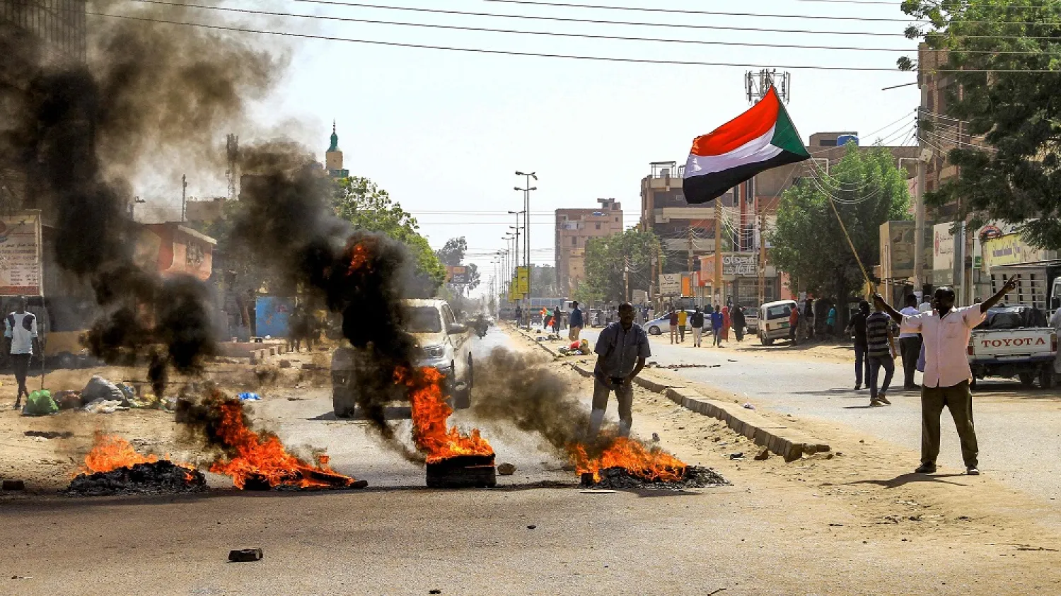 Tires are set aflame by Sudanese protesters during a demonstration against a tentative deal aimed at ending the crisis provoked by last year's military coup, in the Bashdar district in the south of Sudan's capital Khartoum on December 19, 2022. (AFP)