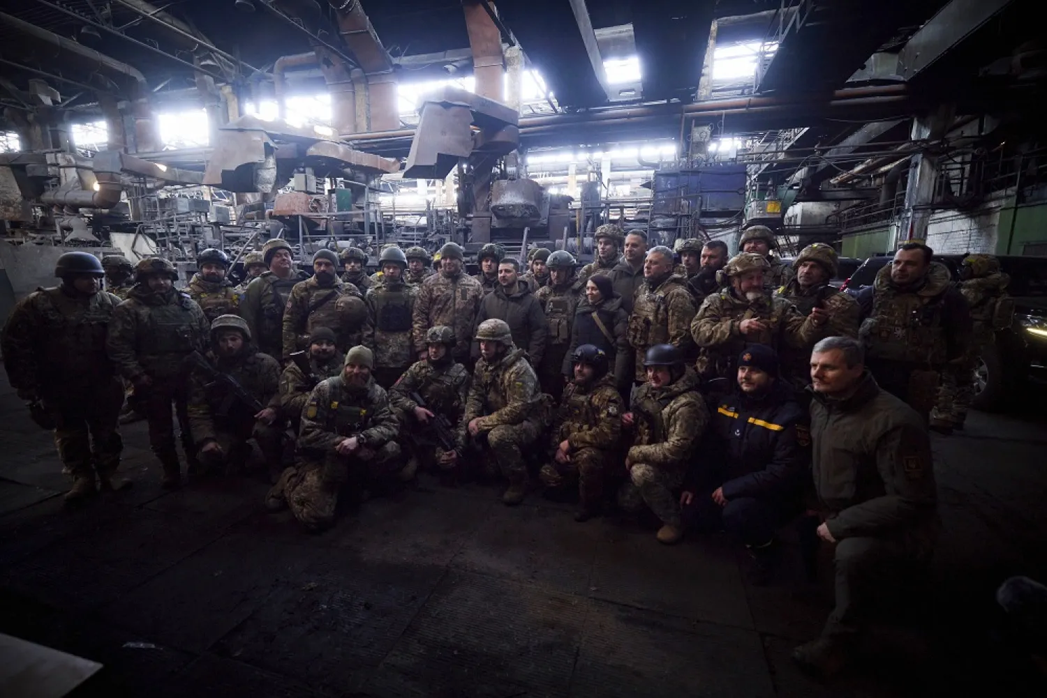 20 December 2022, Ukraine, Bakhmut: Ukrainian President Volodymyr Zelenskyy, stands with soldiers before presenting medals for heroism to frontline troops during a visit to the defensive lines in Bakhmut. (Ukraine Presidency/dpa)