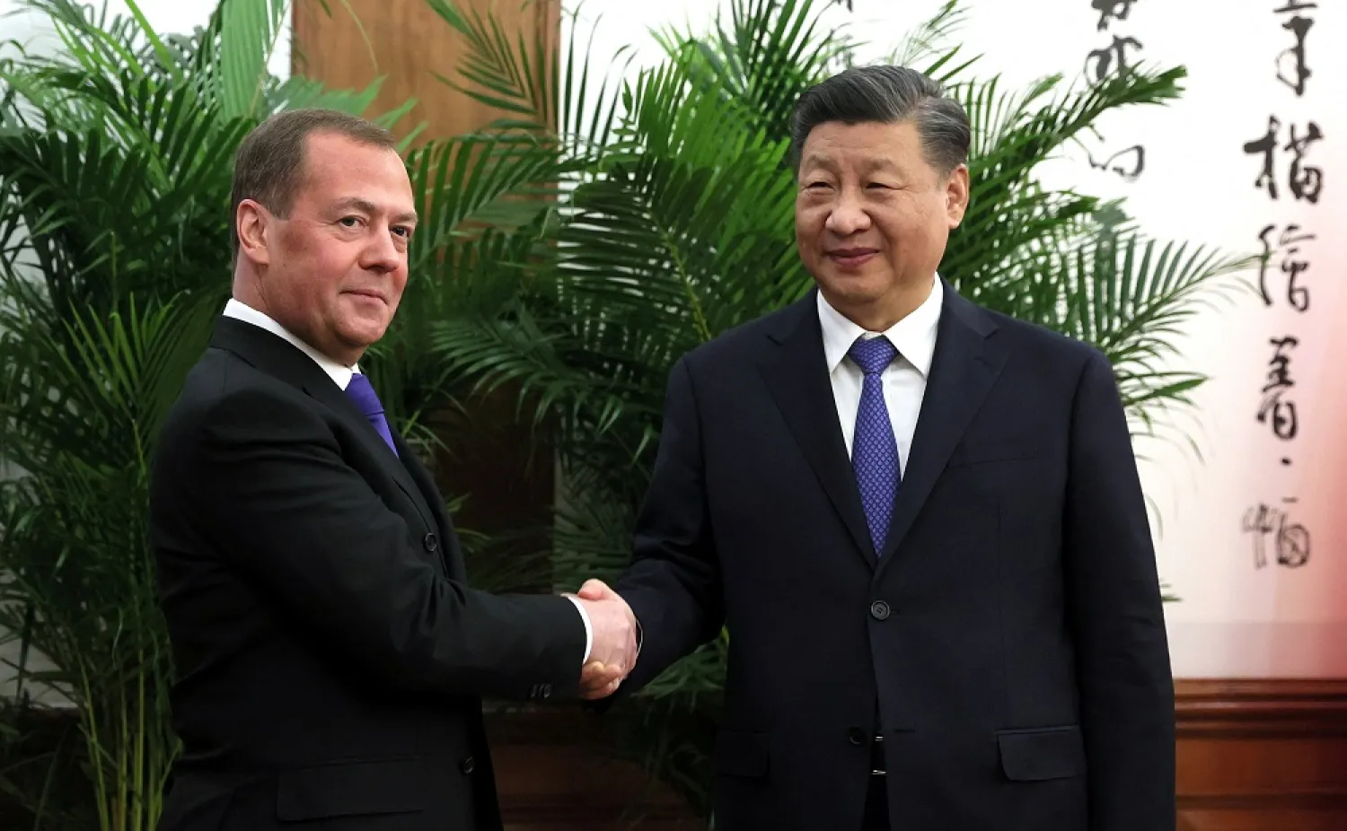 Deputy Chairman of Russia's Security Council Dmitry Medvedev and China's President Xi Jinping shake hands during a meeting in Beijing, China, December 21, 2022. (Reuters)

