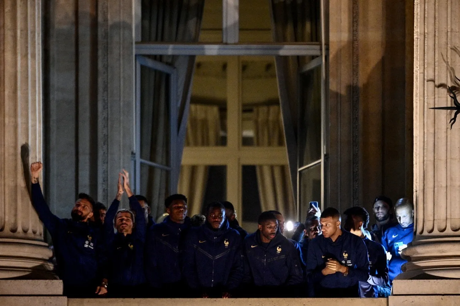 (From L) France's forward Olivier Giroud, France's forward Antoine Griezmann, France's midfielder Aurelien Tchouameni, France's defender Dayot Upamecano, France's forward Ousmane Dembele and France's forward Kylian Mbappe greet supporters at the Hotel de Crillon, a day after the Qatar 2022 World Cup final match against Argentina, at the Place de la Concorde in central Paris on December 19, 2022. (AFP)