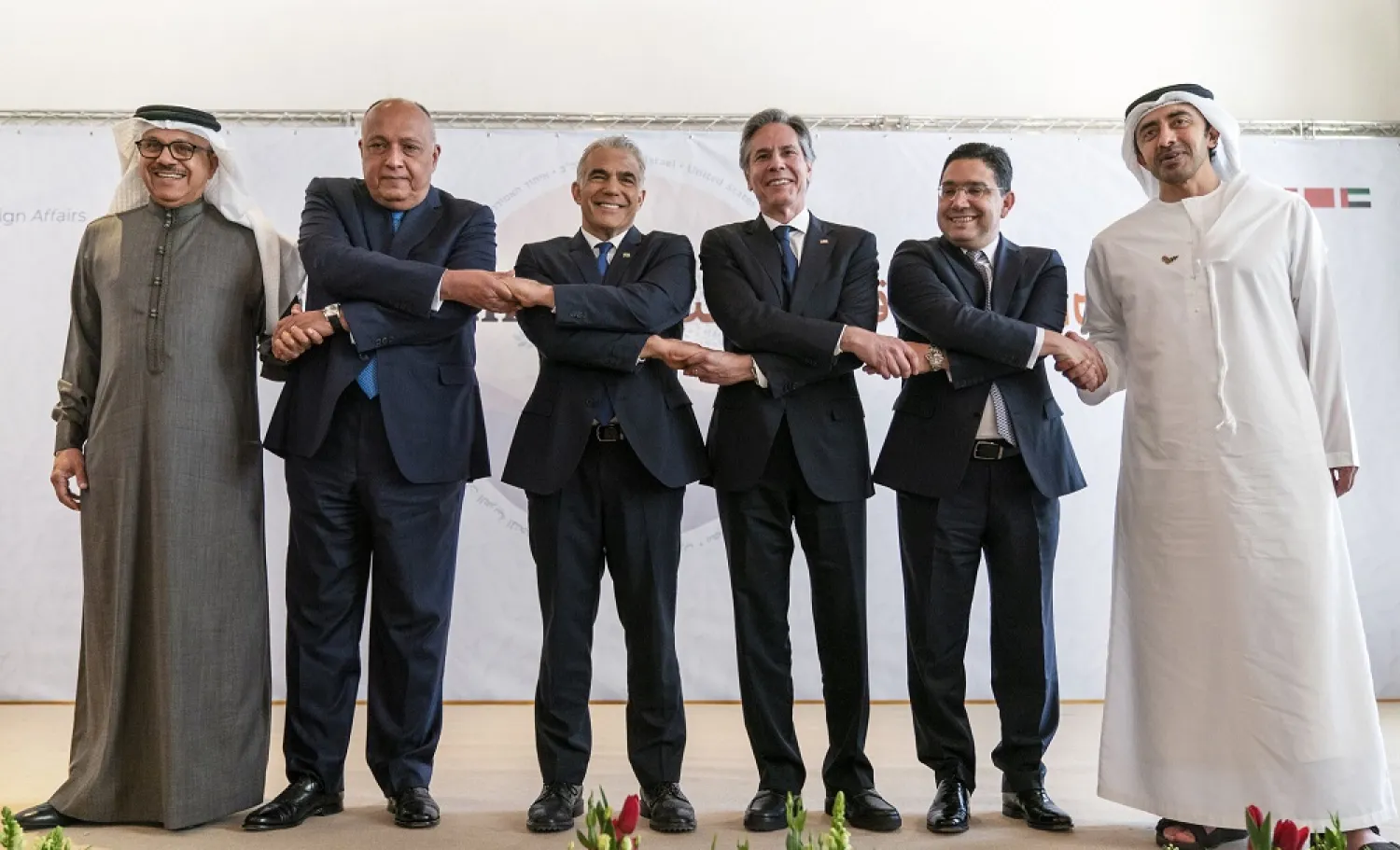 Closing their talks at the Negev Summit, (from left) Bahrain's Foreign Minister Abdullatif bin Rashid al-Zayani, Egypt's Foreign Minister Sameh Shoukry, Israel's Foreign Minister Yair Lapid, US Secretary of State Antony Blinken, Morocco's Foreign Minister Nasser Bourita, and United Arab Emirates' Foreign Minister Sheikh Abdullah bin Zayed Al Nahyan, pose for a photograph, March 28, 2022, in Sde Boker, Israel. (AP)
