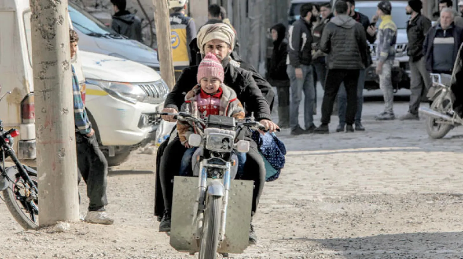 رجل يضع صورة الرئيس العراقي الراحل صدام حسين في مقدمة دراجة نارية في مدينة الباب الثلاثاء (أ.ف.ب)