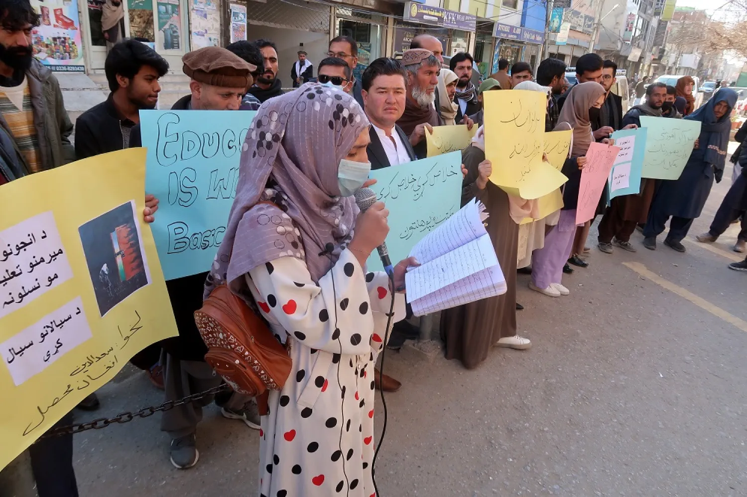 Afghan refugees in Pakistan hold placards during a protest as they demand the Taliban government to allow education for girls, in Quetta, the provincial capital of Balochistan province, Pakistan, 24 December 2022. (EPA)