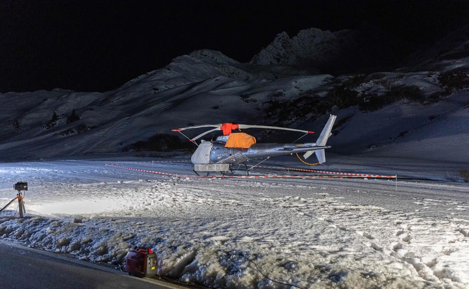 This photograph taken on December 25, 2022 shows a covered rescue helicopter at the ski resort of Lech Zurs after an avalanche allegedly caused the death of at least ten skiers in Zurs, eastern Austria. (AFP)