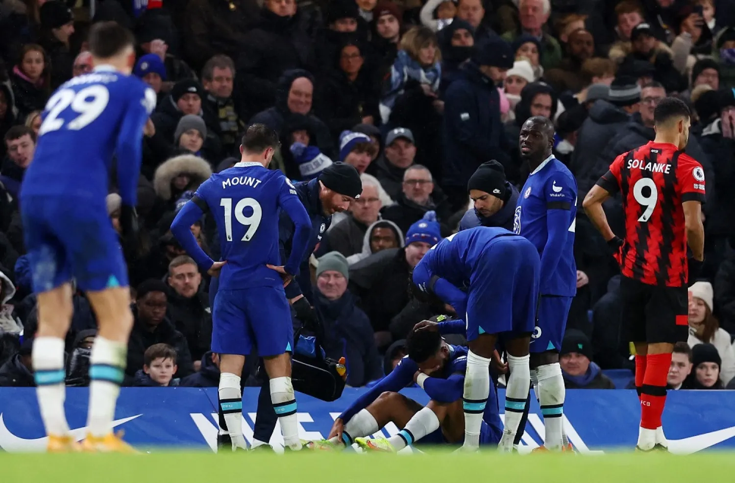 Football - Premier League - Chelsea v AFC Bournemouth - Stamford Bridge, London, Britain - December 27, 2022 Chelsea's Reece James looks dejected after sustaining an injury as Mason Mount and Kalidou Koulibaly look on. (Reuters)