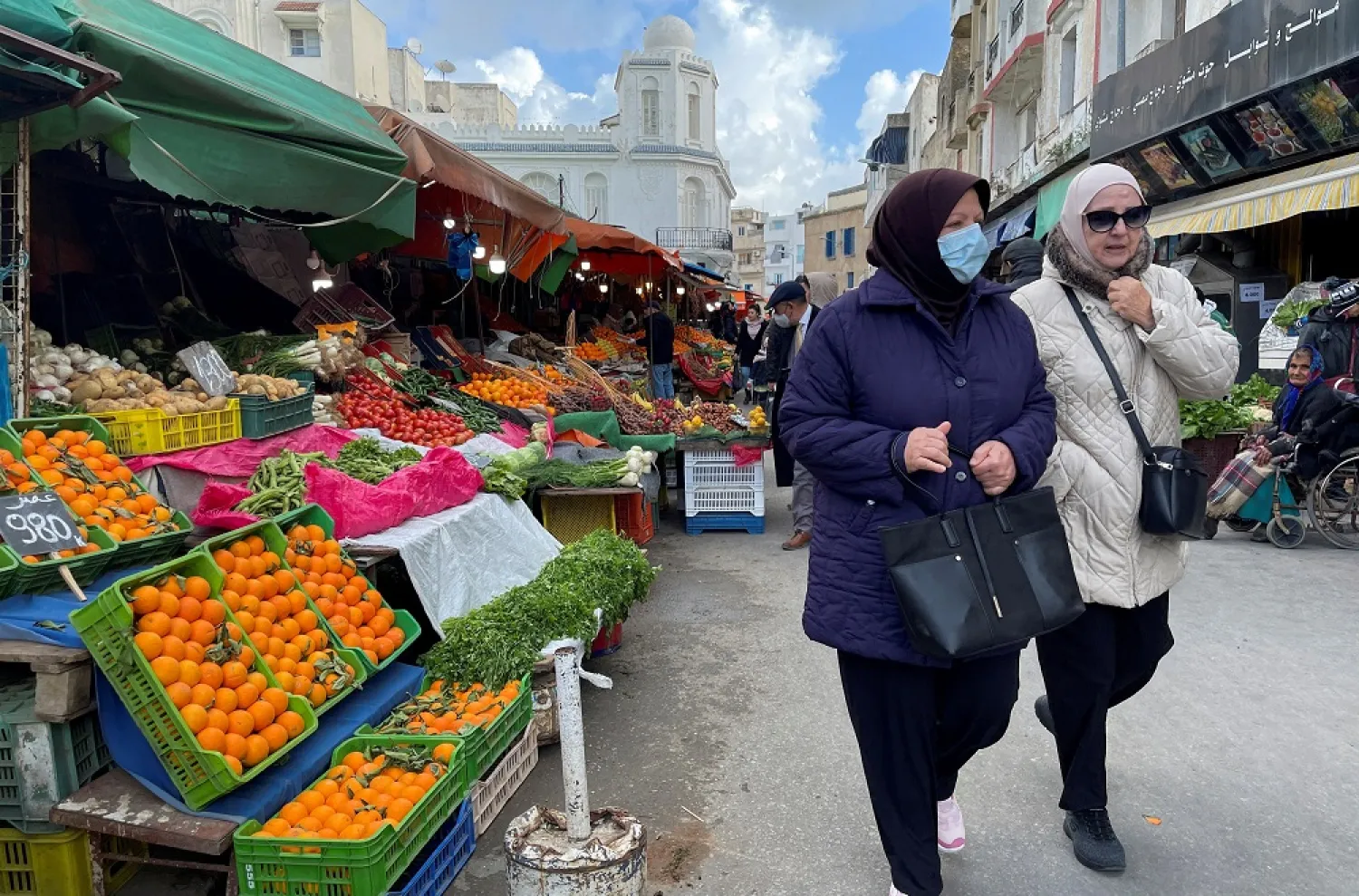  Women walk along a market in Tunis, Tunisia, February 1, 2022. Picture taken February 1, 2022. (Reuters)