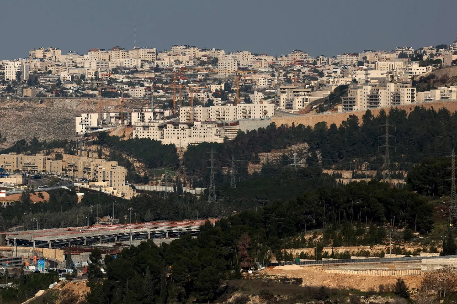This picture shows a general view of Ramat Shlomo, a Jewish settlement in the Israeli-annexed eastern sector of Jerusalem, on December 30, 2022, with the east Jerusalem neighborhood of Beit Hanina (background). (AFP)
