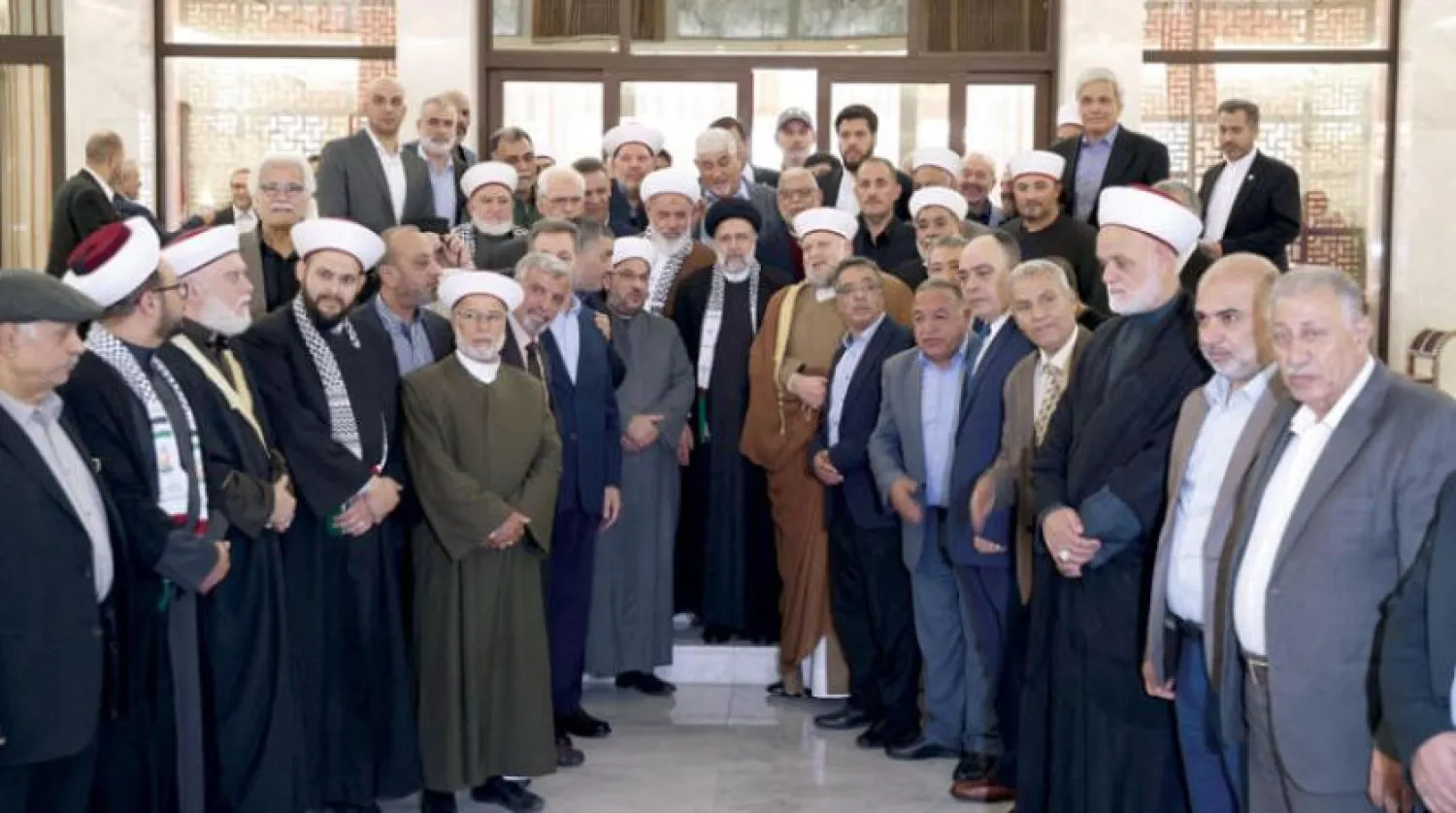 A picture released by the Iranian Presidency shows the meeting between Iranian President Ebrahim Raisi and representatives of Palestinian factions in Damascus (Reuters)