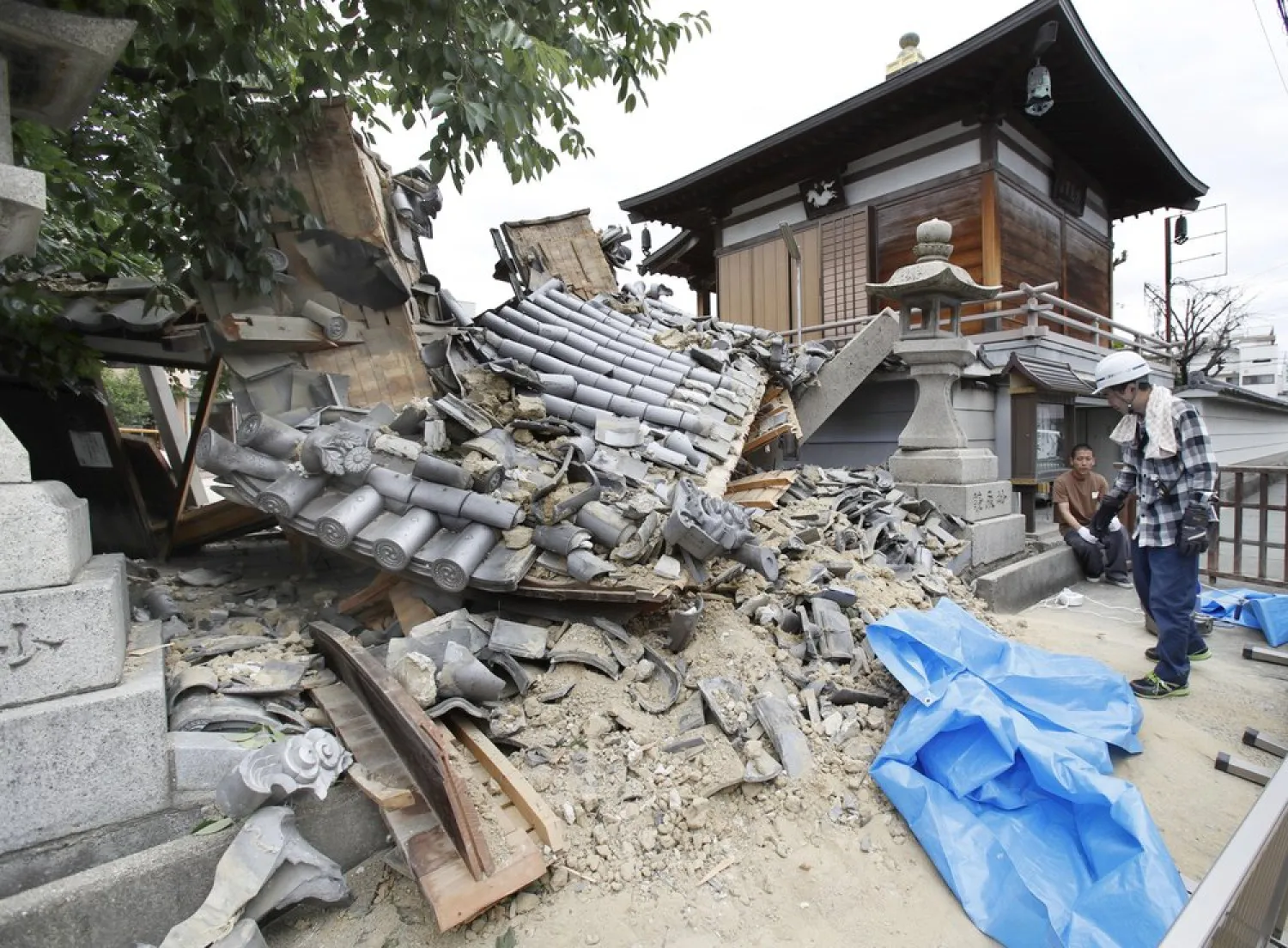 File photo: The gate of Myotoku-ji temple collapses after an earthquake hit Ibaraki City, Osaka, western Japan, Monday, June 18, 2018. (Yosuke Mizuno/Kyodo News via AP)
