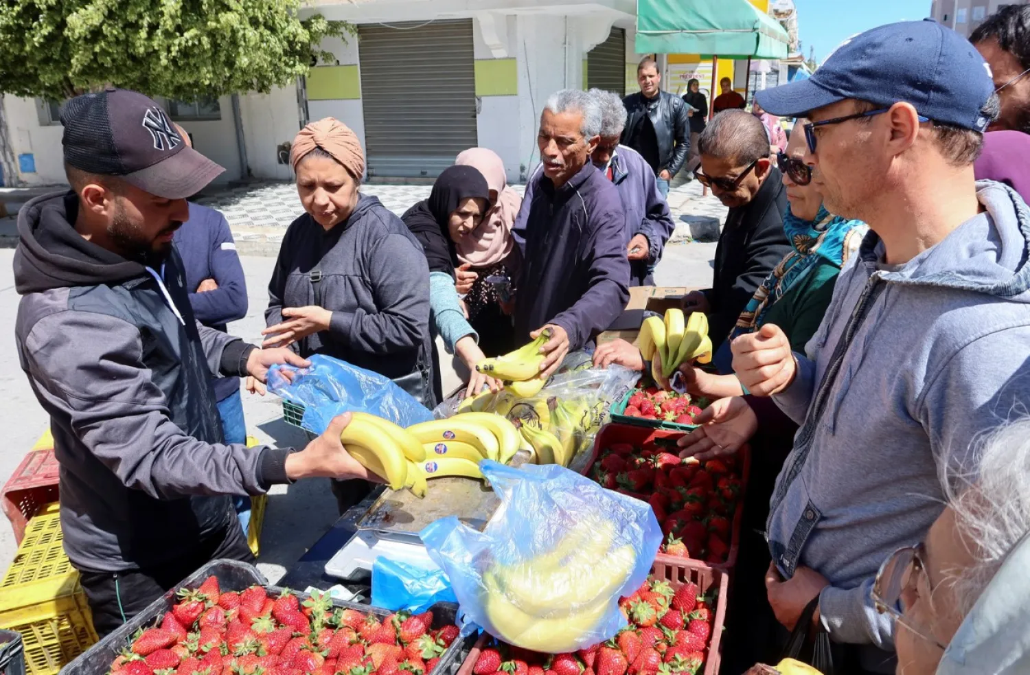 People buy fruits in Ben Arous, Tunisia (Reuters)
